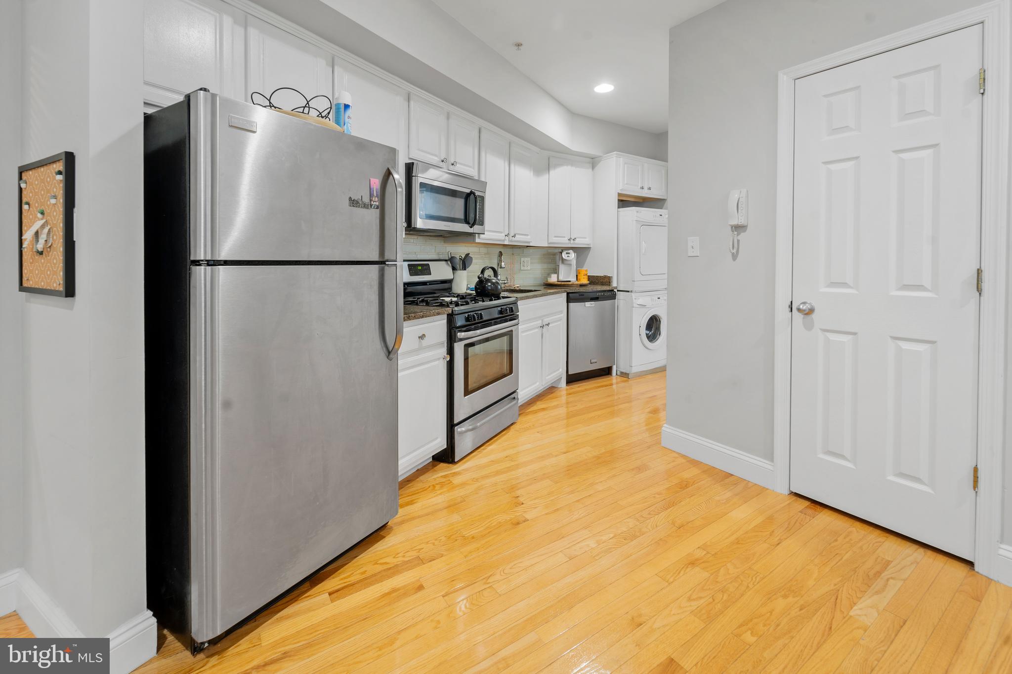 a kitchen with stainless steel appliances a refrigerator and a stove