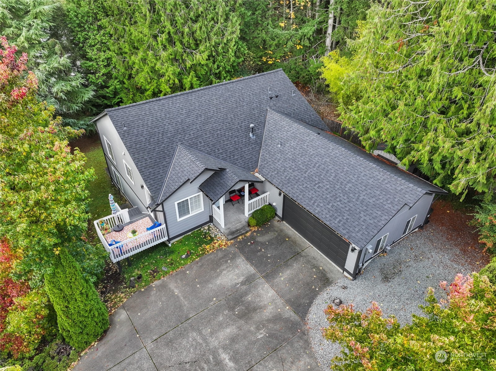 a aerial view of a house with a yard and large trees