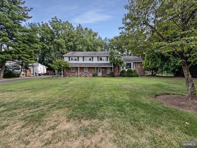 a view of a house with a yard and sitting area