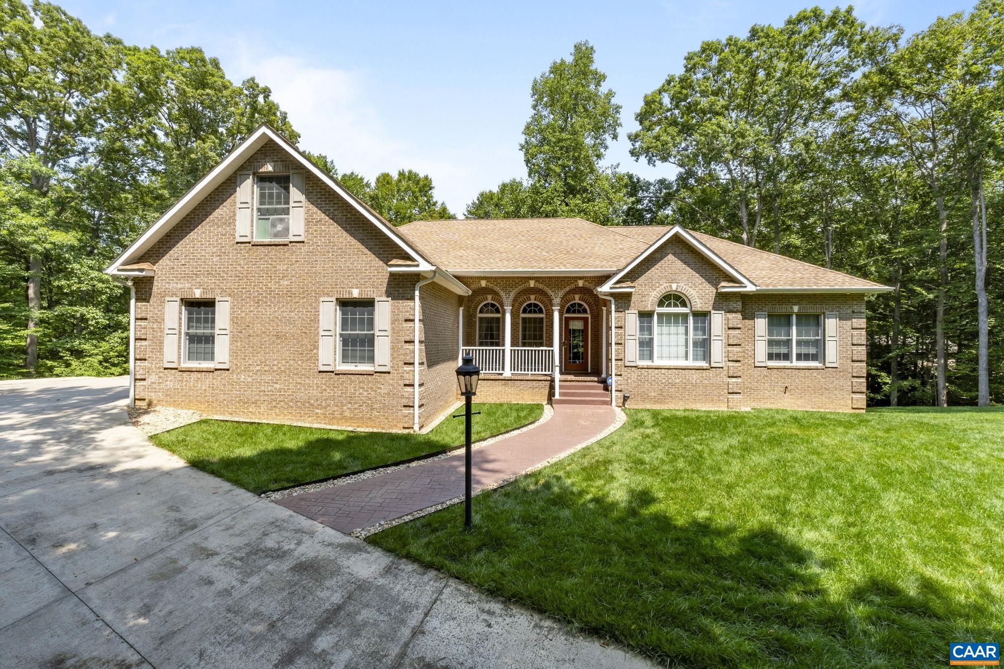 a front view of a house with a yard and porch