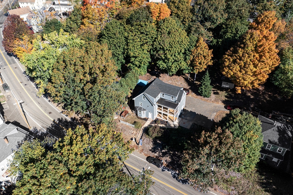 view of a house with a yard and garden