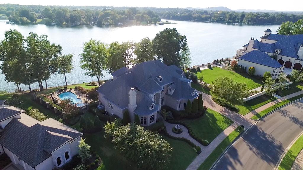 an aerial view of a house with garden space and lake view