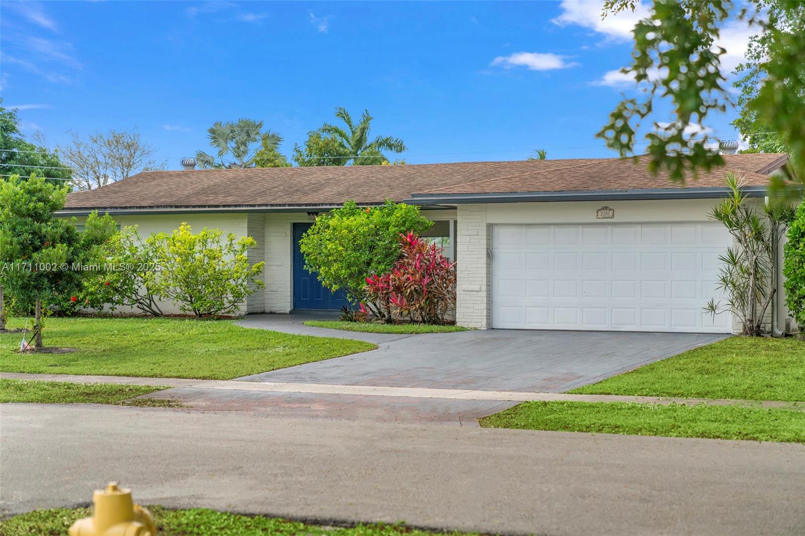 a front view of a house with a yard and a garage