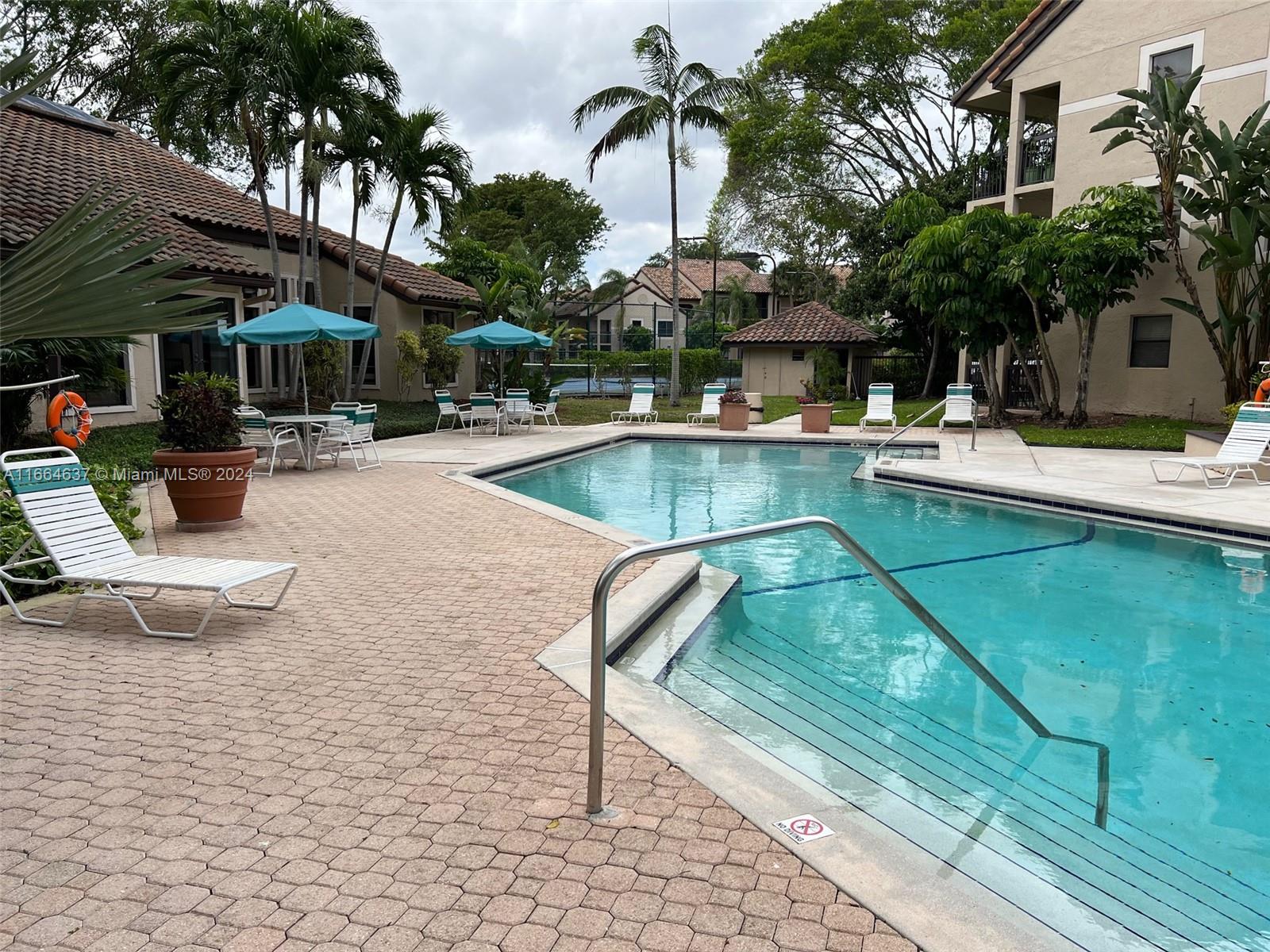 a view of swimming pool with outdoor seating and plants