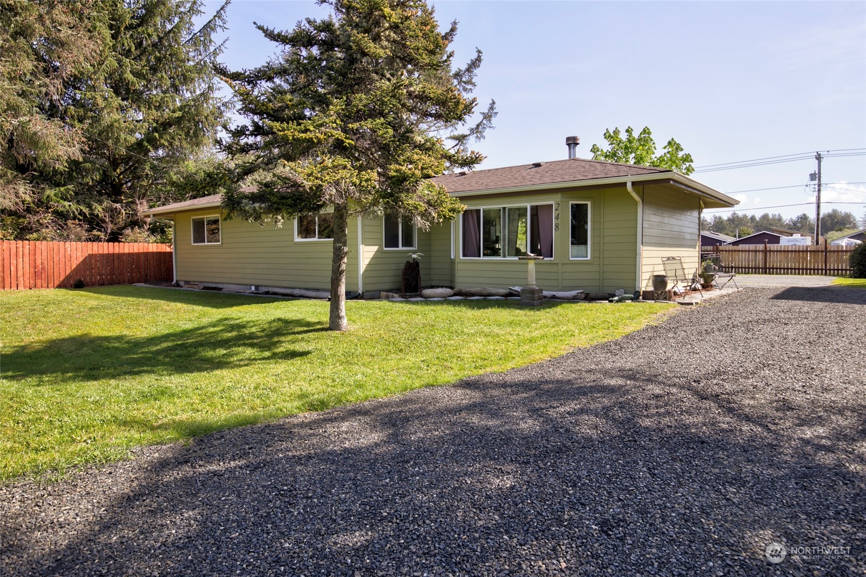 a view of a house with a yard and a tree