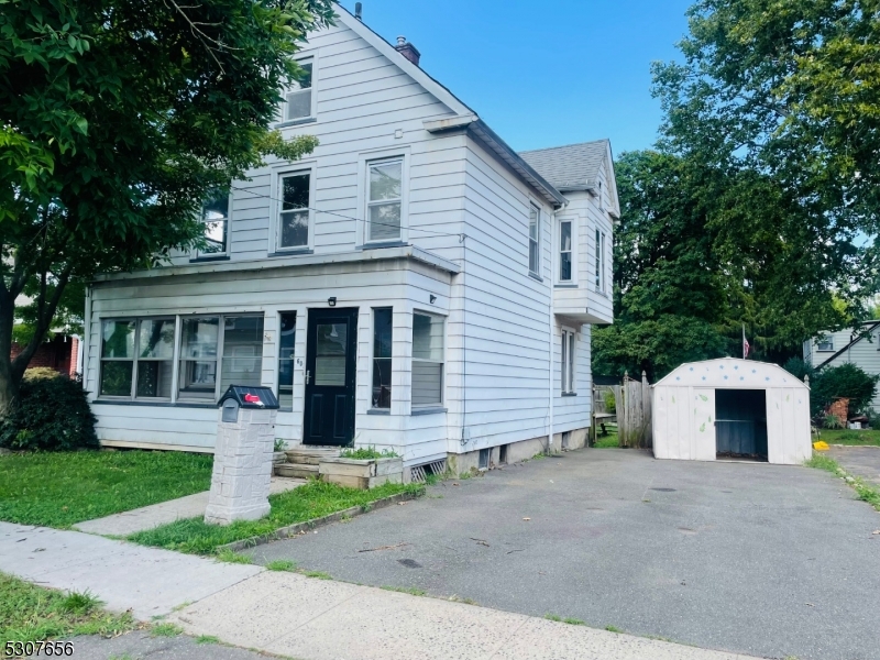 a view of a house with a yard and plants