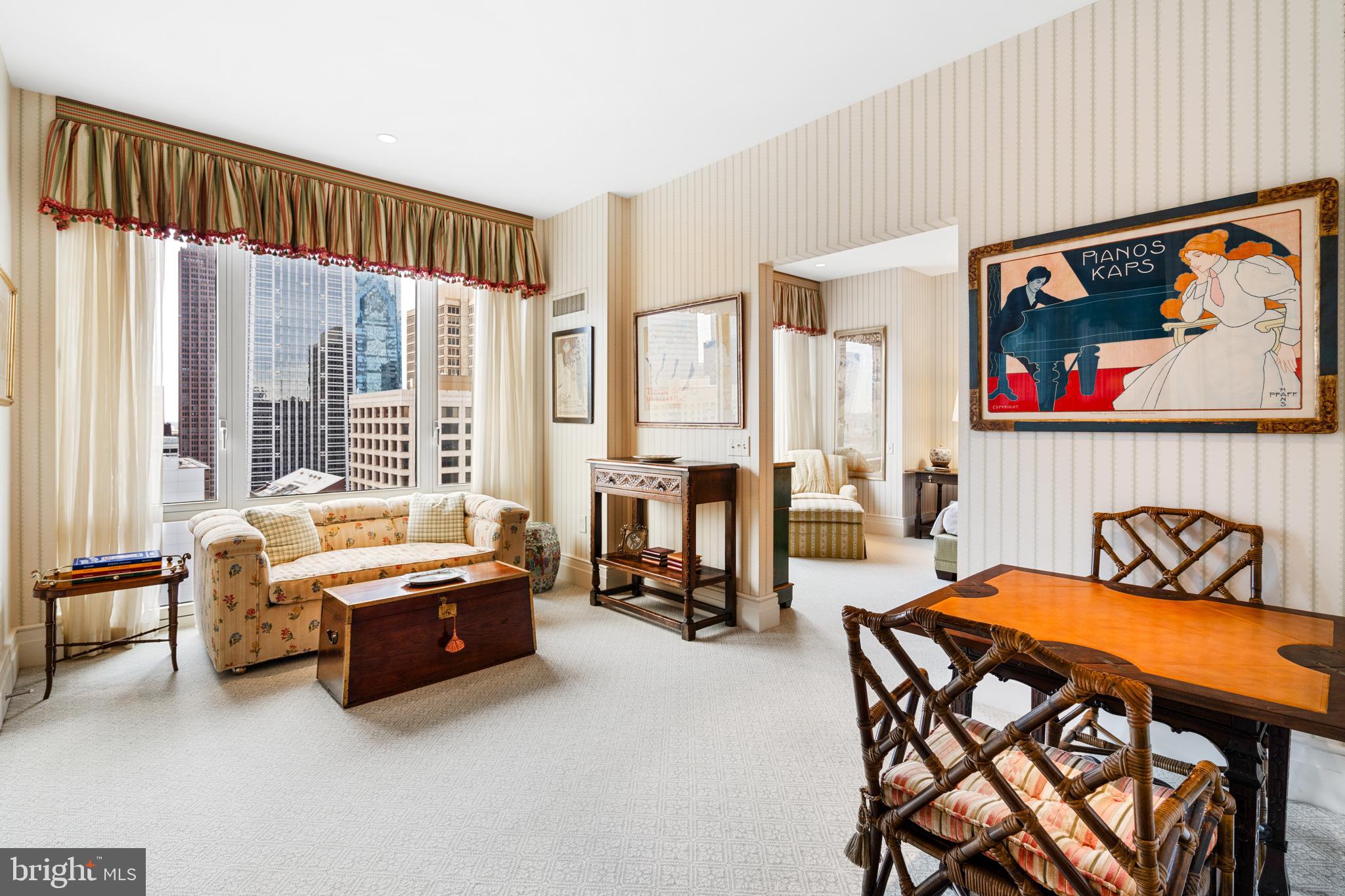 a bedroom with furniture and a large window