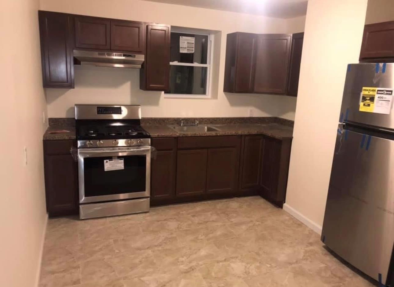 Kitchen with dark brown cabinetry, stainless steel appliances, and sink