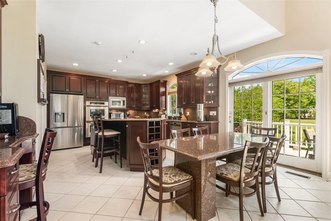 Magnificent kitchen with work area (left side of picture) and casual eating area (beneath chandelier) and sliding glass doors to deck