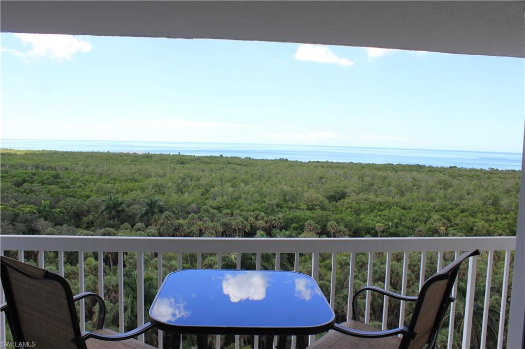 a view of a balcony with wooden floor and fence