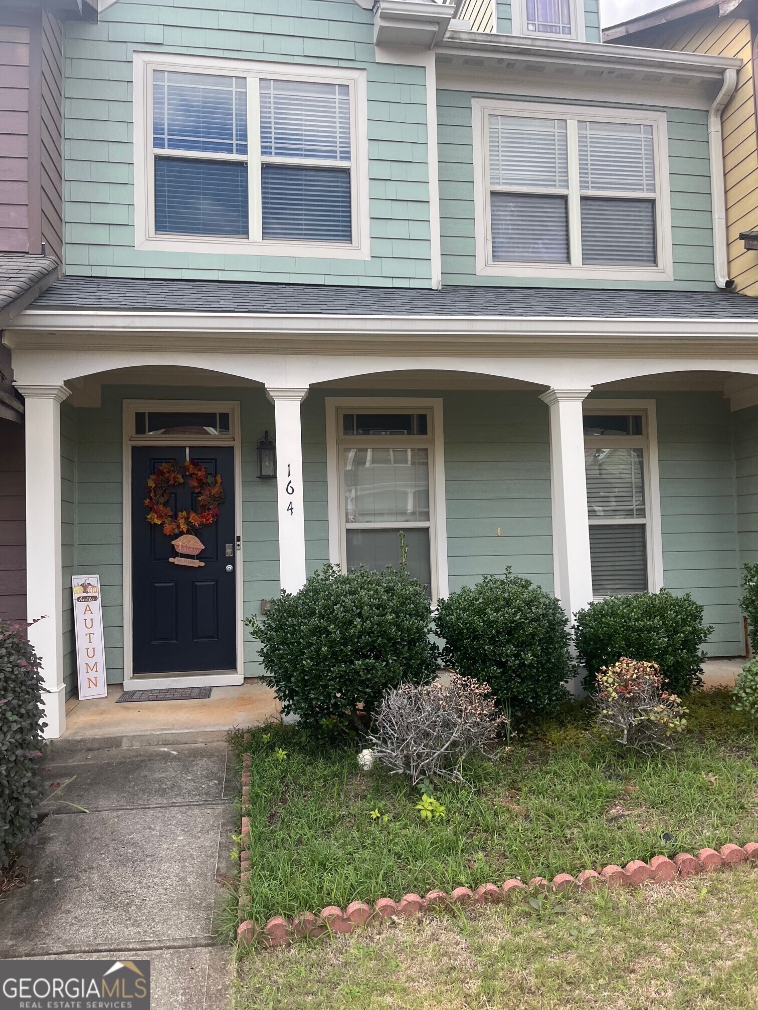 a front view of a house with garden