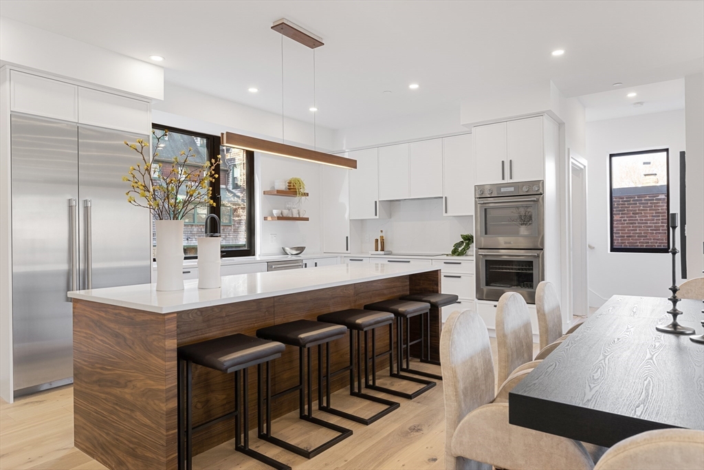 a kitchen with stainless steel appliances kitchen island granite countertop a sink and cabinets