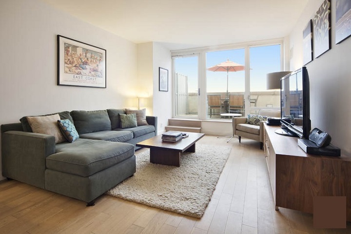 a living room with furniture wooden floor and a flat screen tv