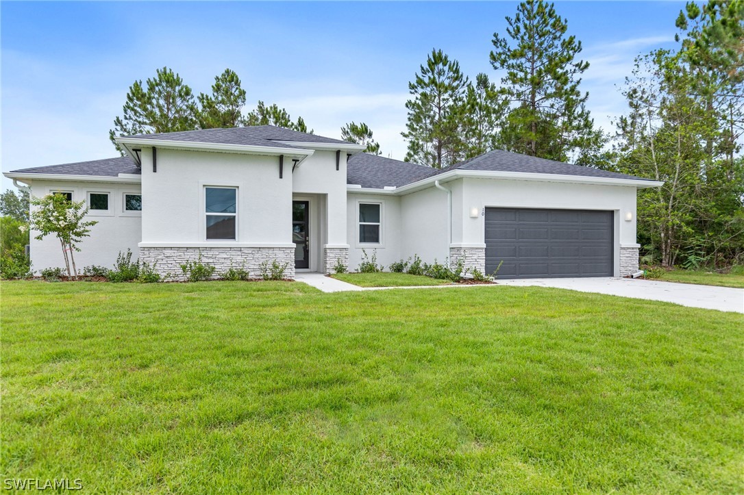 a front view of house with yard and green space