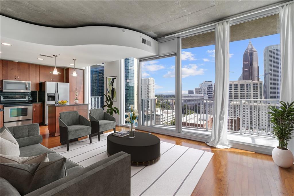 a living room with furniture and a floor to ceiling window