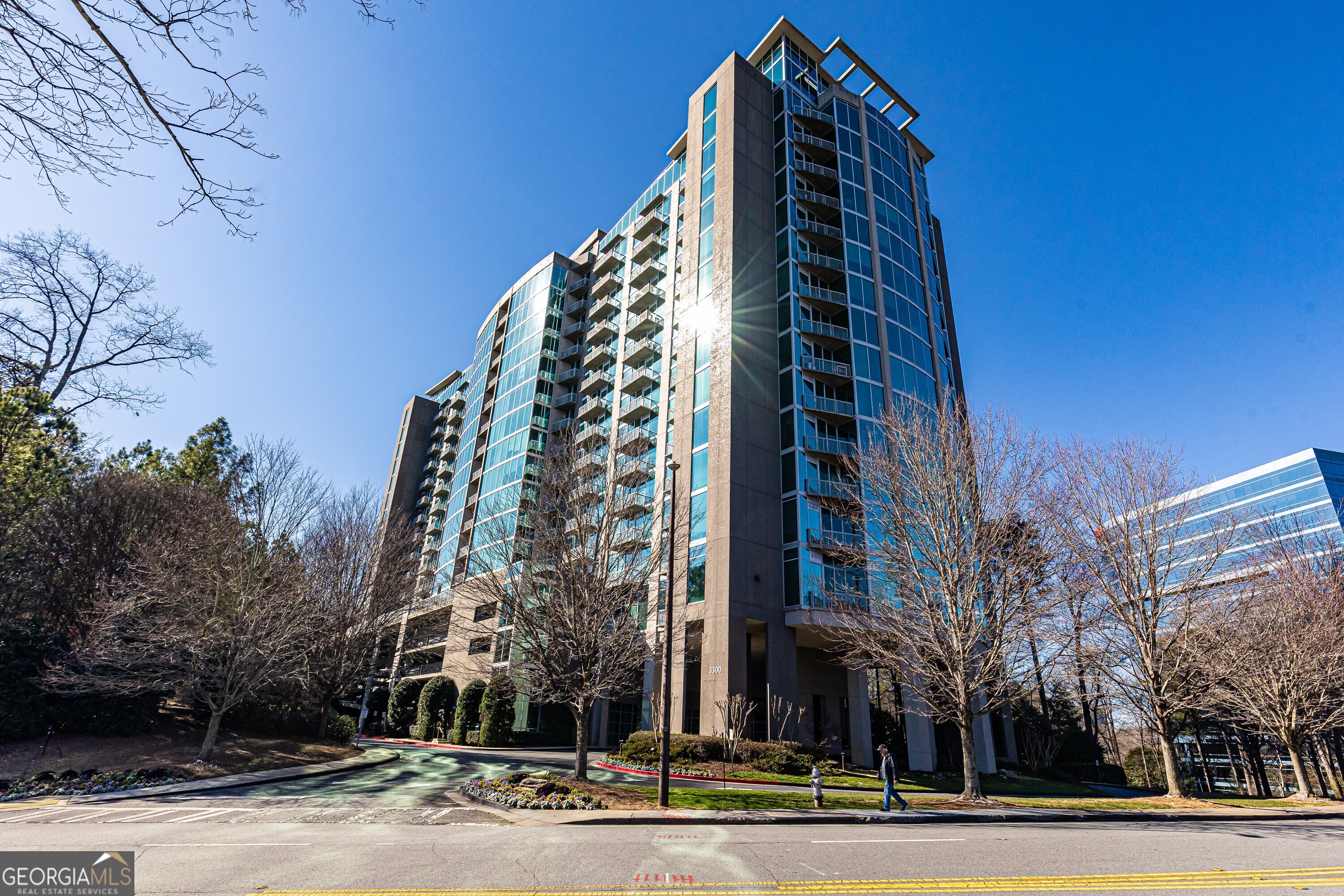 a view of a tall building next to a road