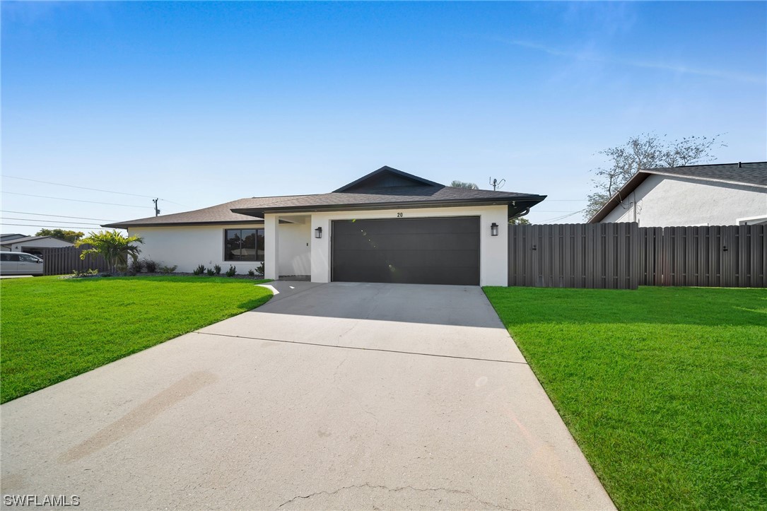 a front view of house with yard and green space