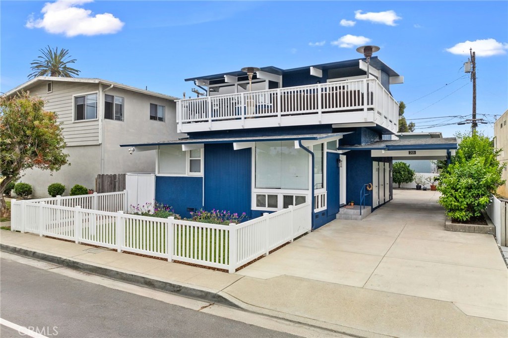 a view of a house with a balcony and furniture