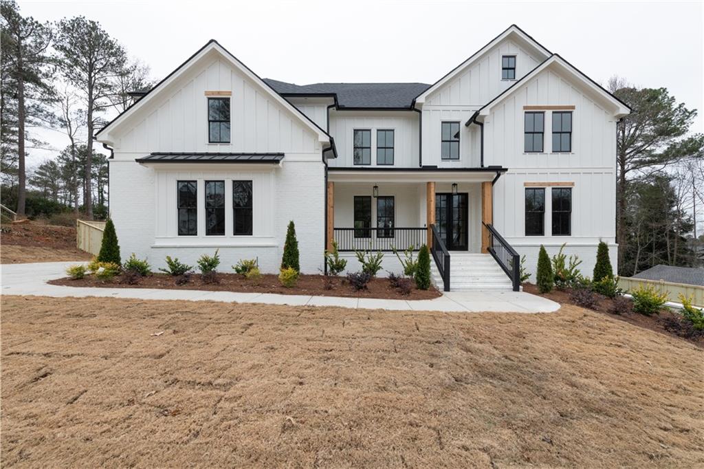 a front view of a house with yard and parking