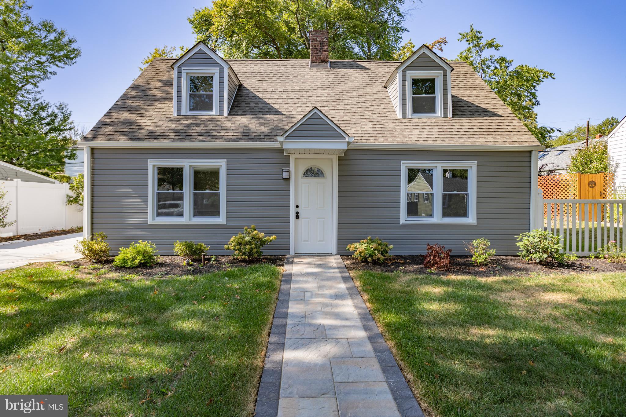 a front view of brick house with a yard