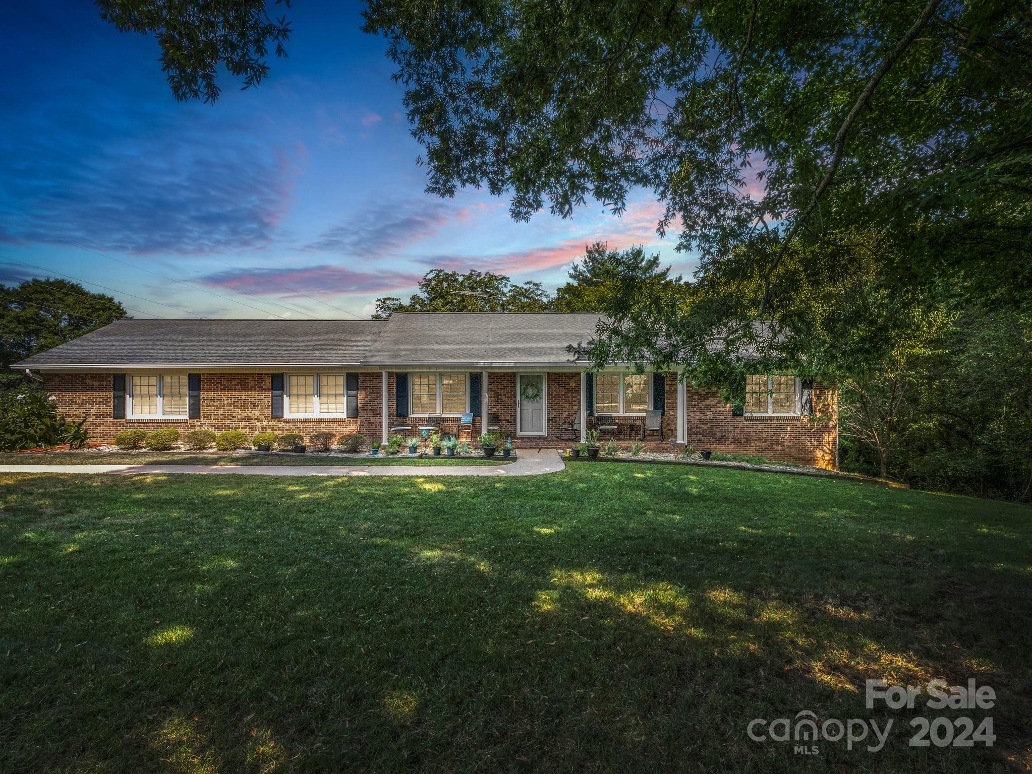 a front view of house with yard and outdoor seating