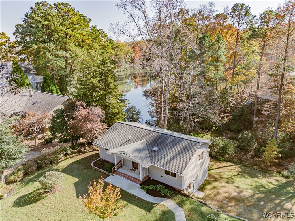 an aerial view of a house with yard swimming pool and outdoor seating