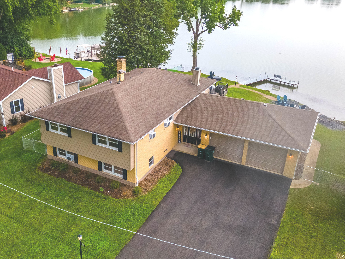 a aerial view of a house with a yard and a patio