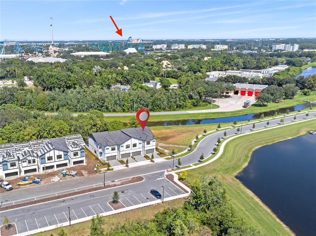 an aerial view of a house with a garden and lake view