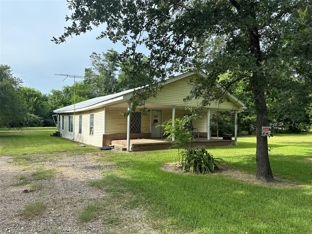 a view of a house with a yard and sitting area