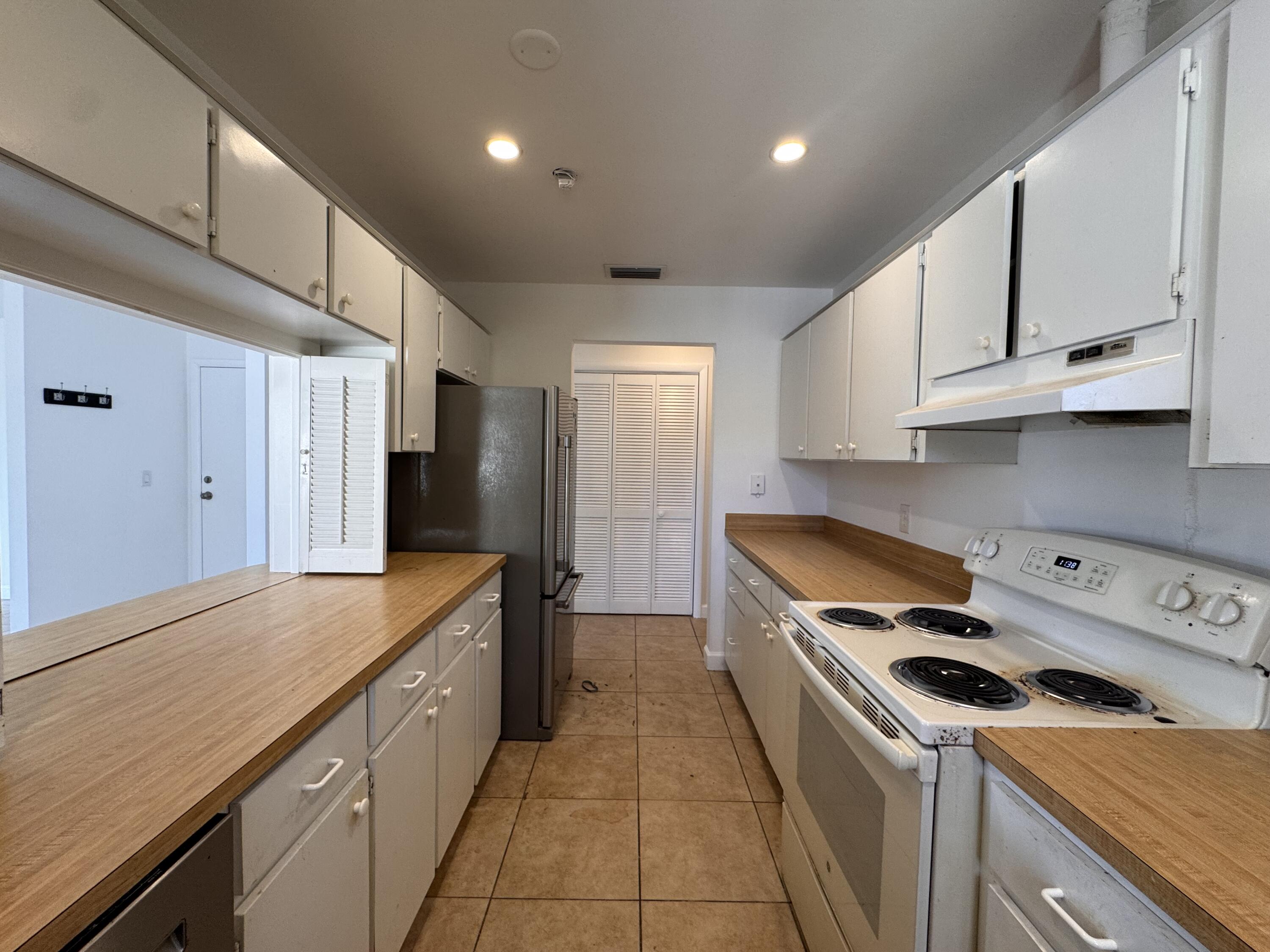 a kitchen with stainless steel appliances granite countertop a sink a stove and a refrigerator