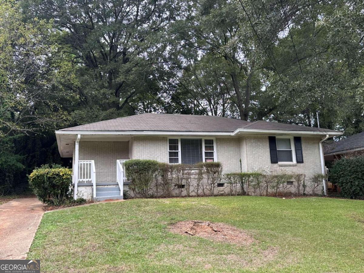 a front view of house with yard and green space