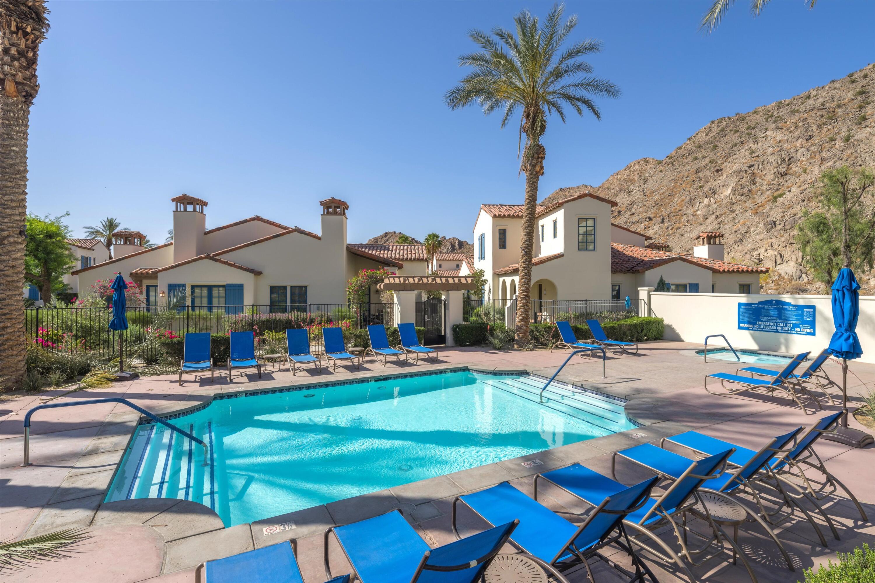 a front view of multiple houses with swimming pool