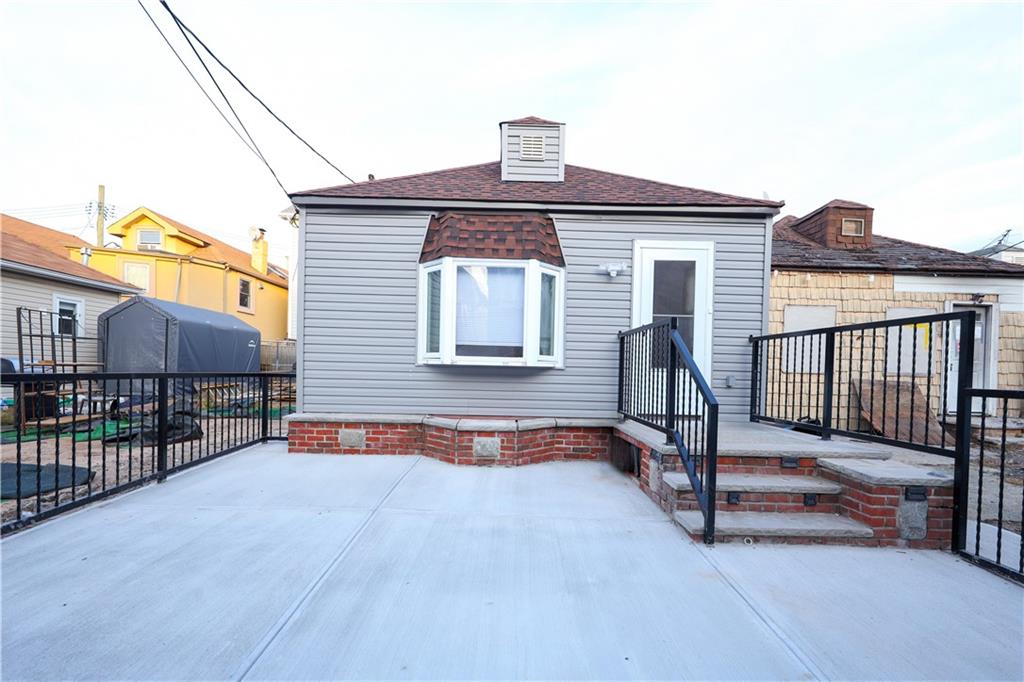 a view of a house with a wooden deck