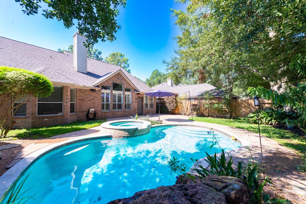 a view of a house with swimming pool and a yard