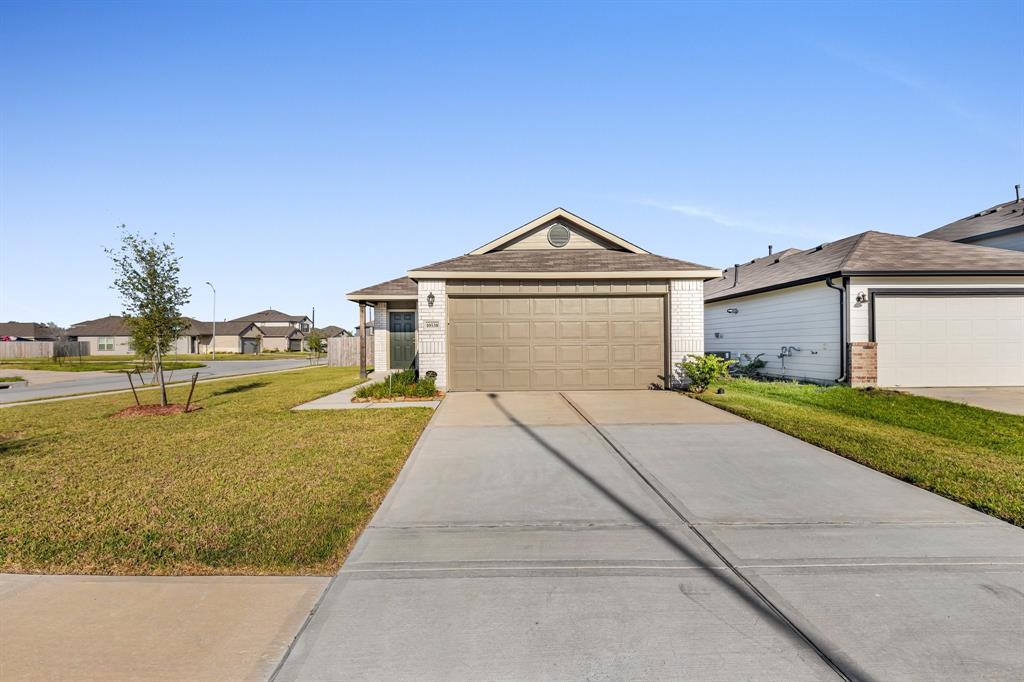 a front view of a house with a yard and garage