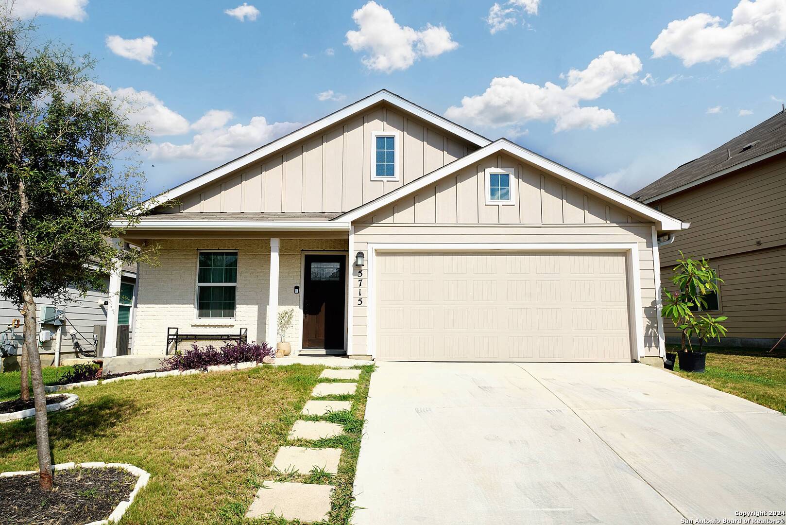 a front view of a house with garden