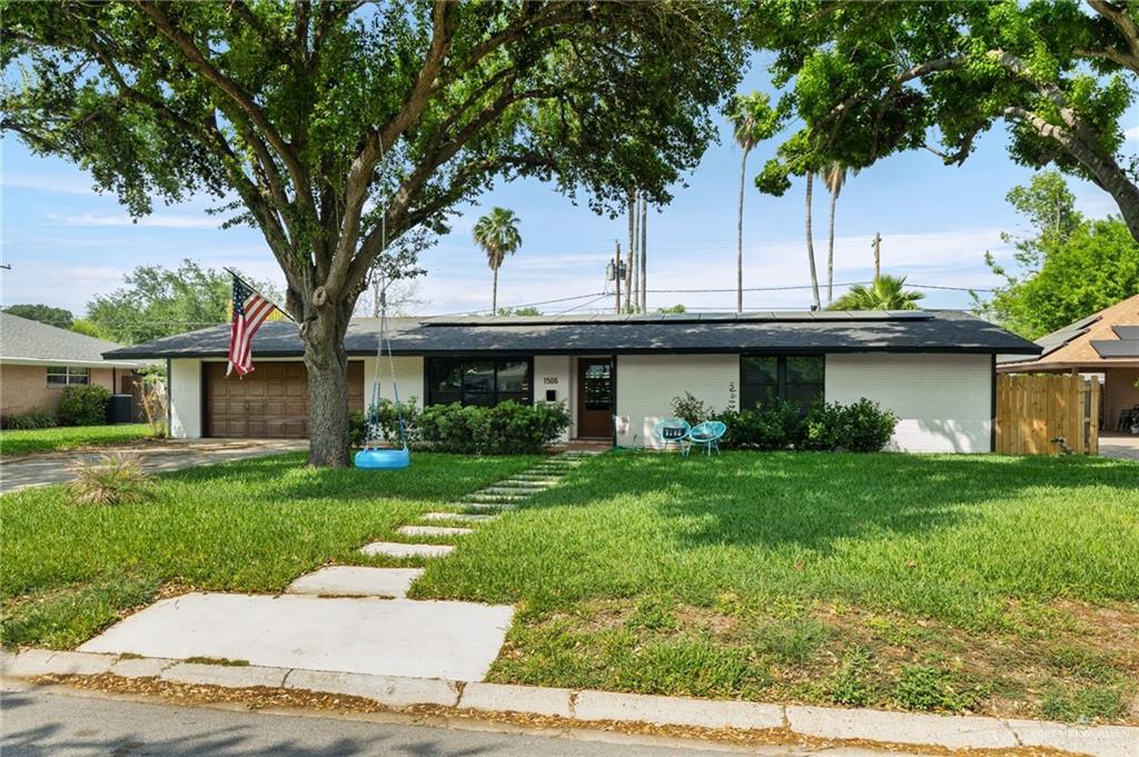 a view of a house with a yard and tree s