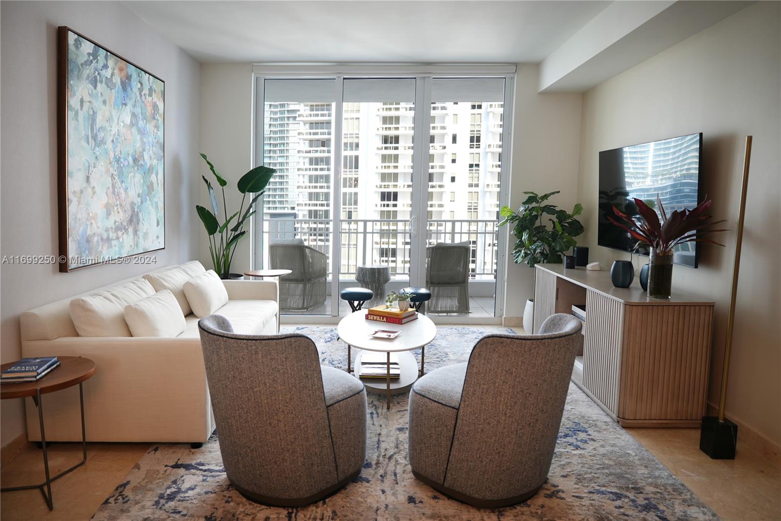 a living room with fireplace furniture and a large window