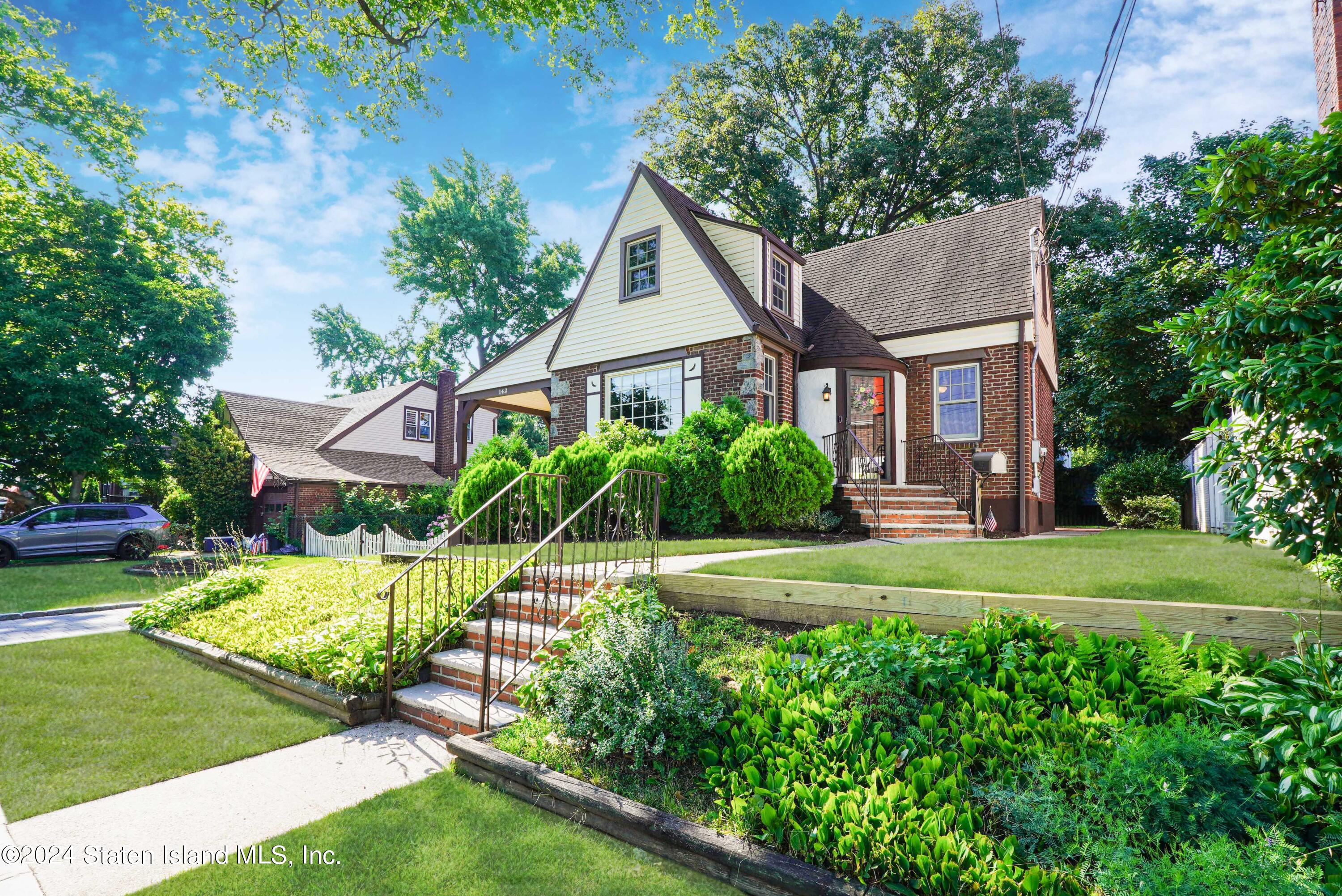 a front view of a house with a yard and porch