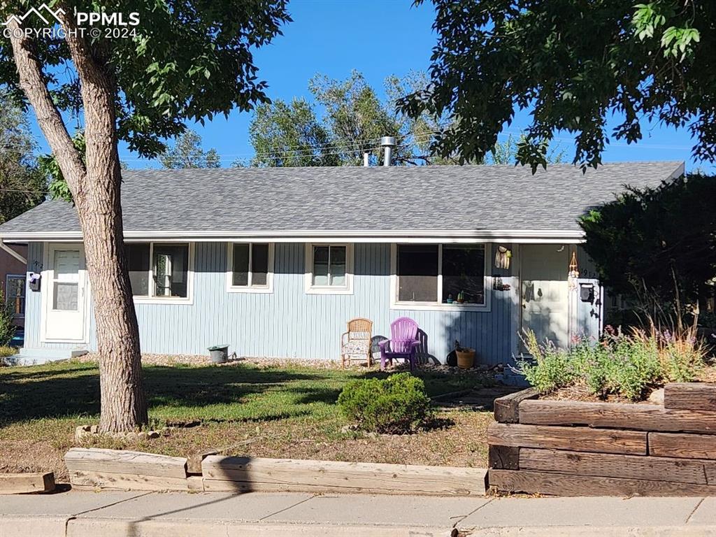 View of front of property with a front yard