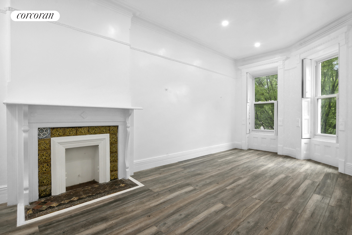 a view of an empty room with a fireplace and a window