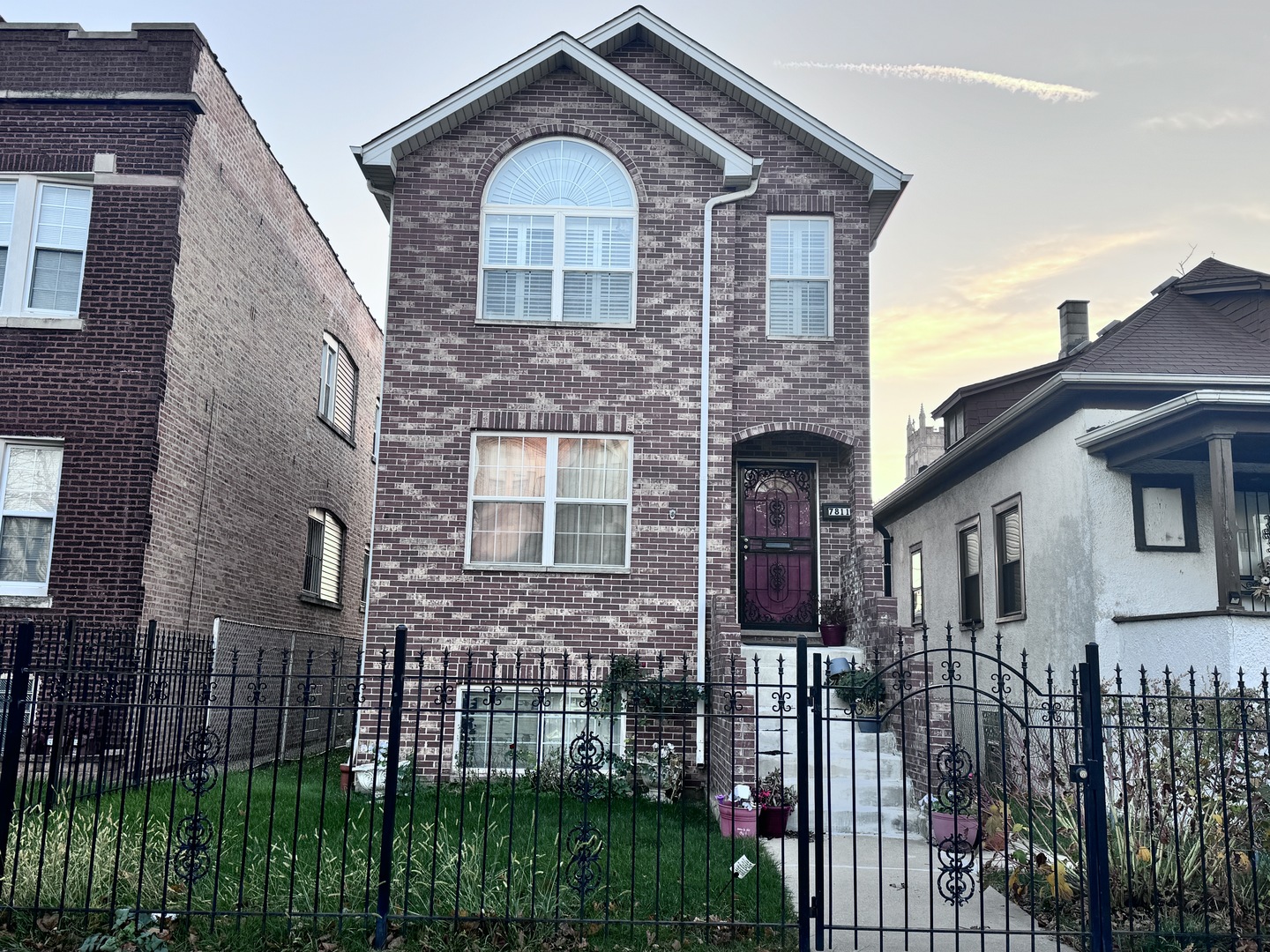 a front view of a house with a garden