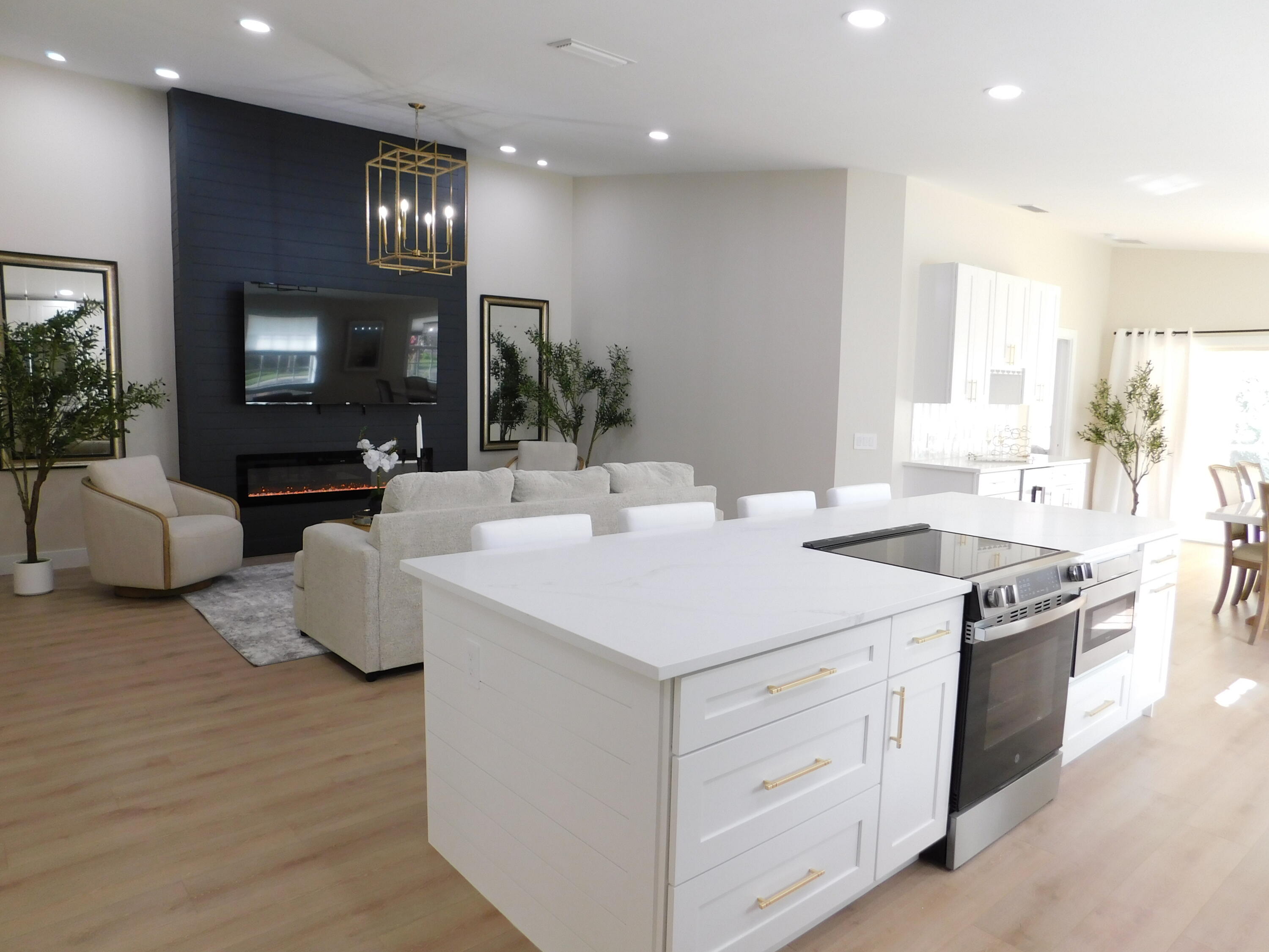 a kitchen with kitchen island granite countertop a sink and a stove top oven