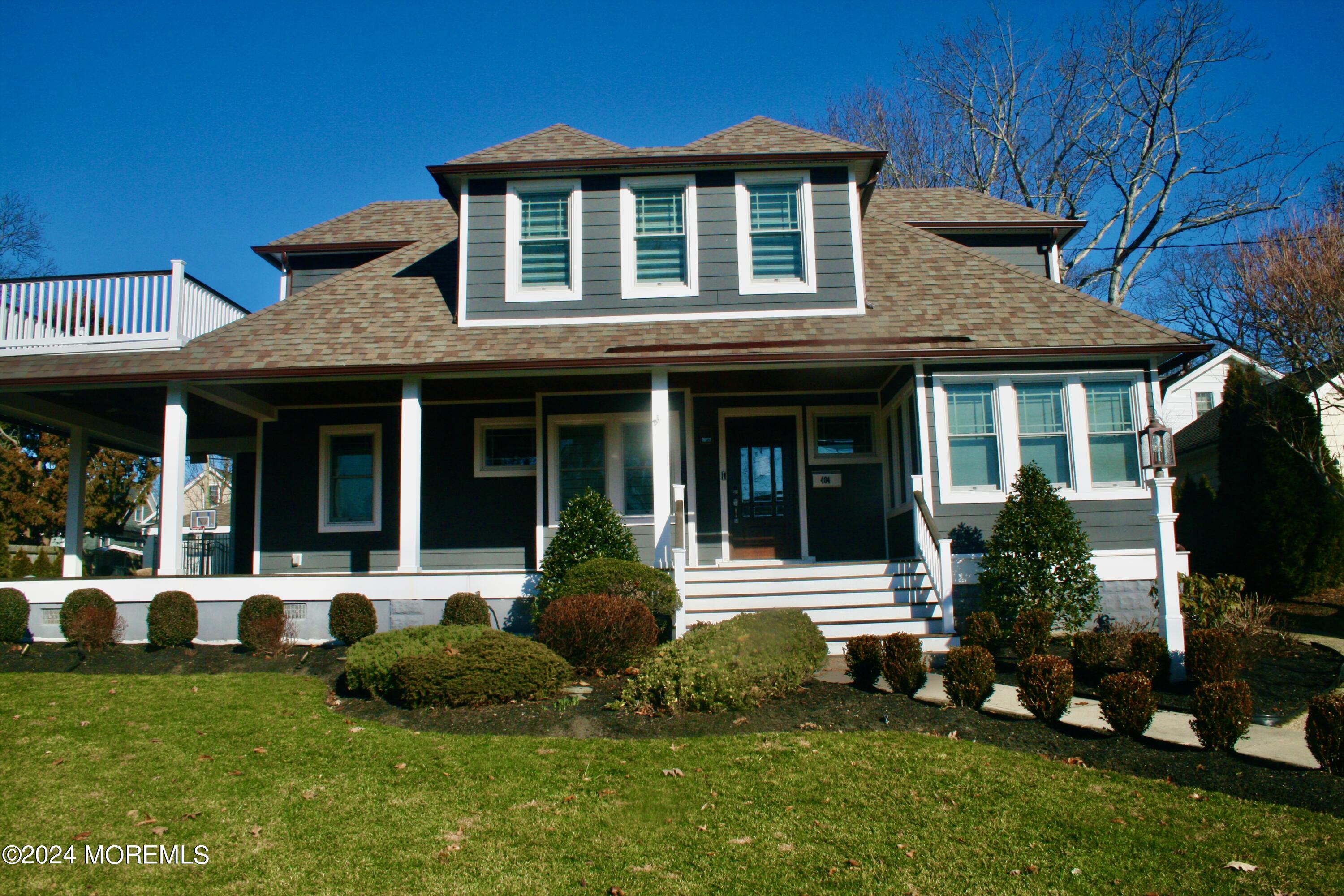 a front view of a house with a yard and porch