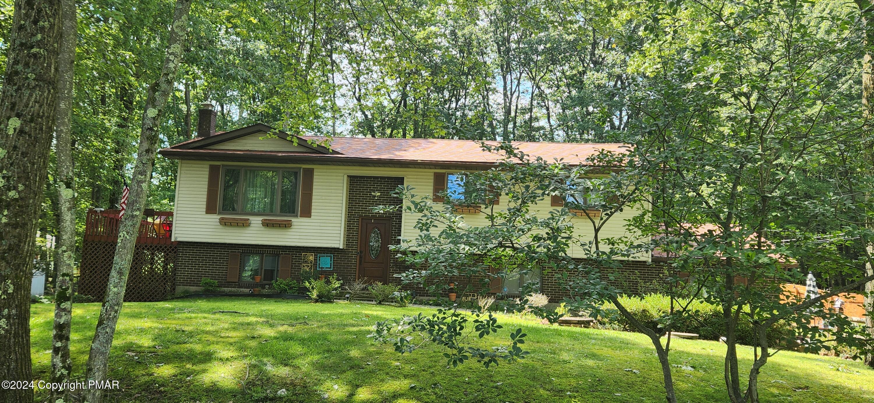 a front view of a house with a garden