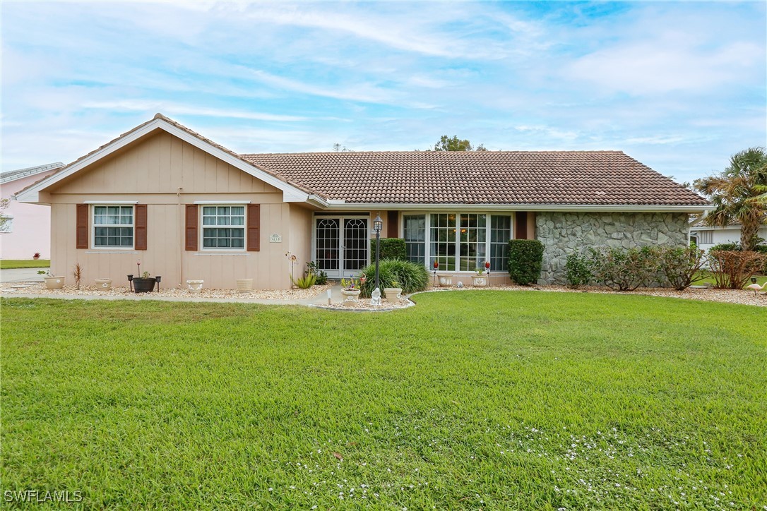 a front view of house with yard and green space