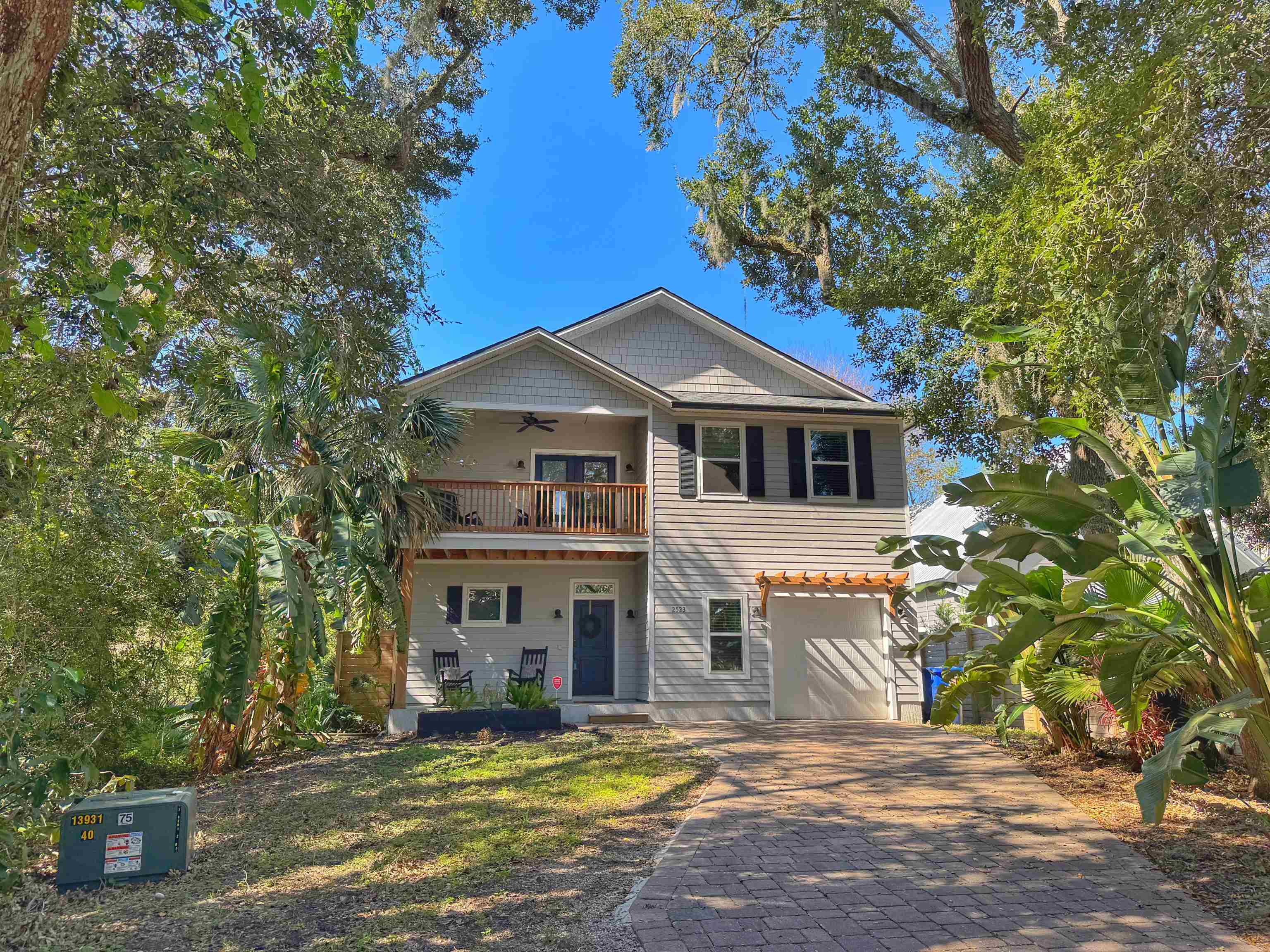 a house that has a tree in front of it