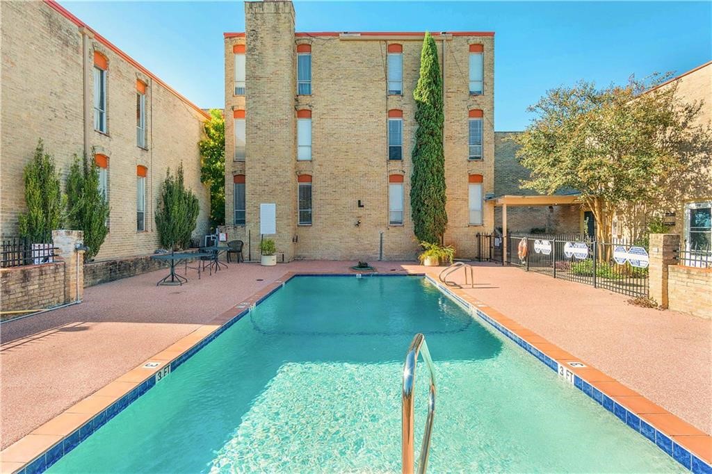 a swimming pool with outdoor seating and yard