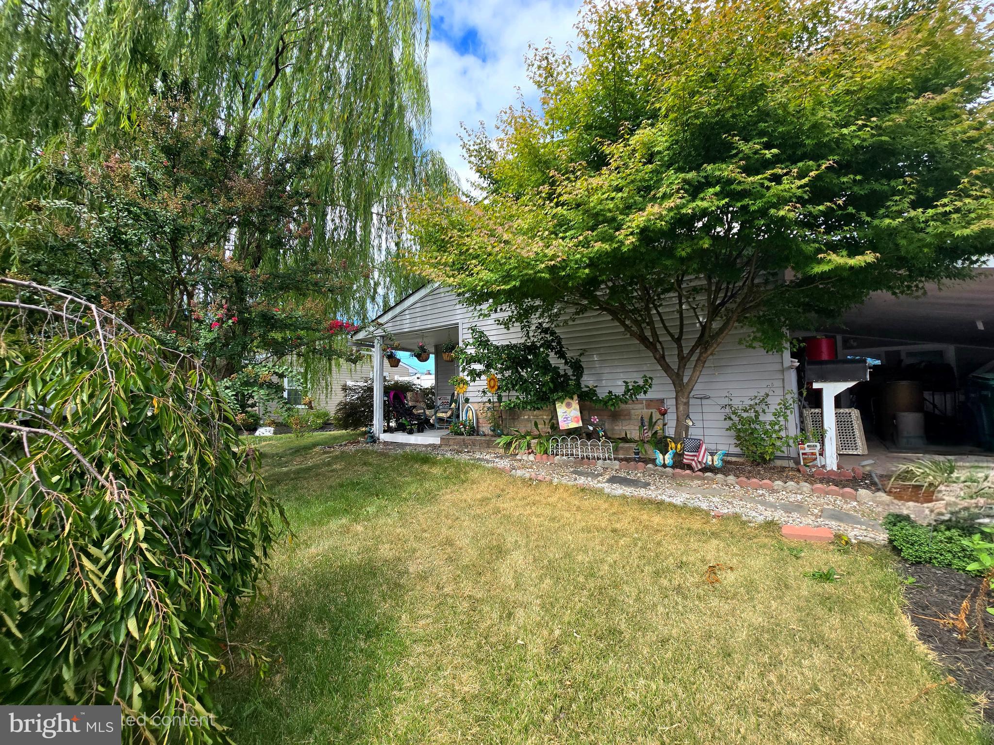 a view of a house with a yard and sitting area