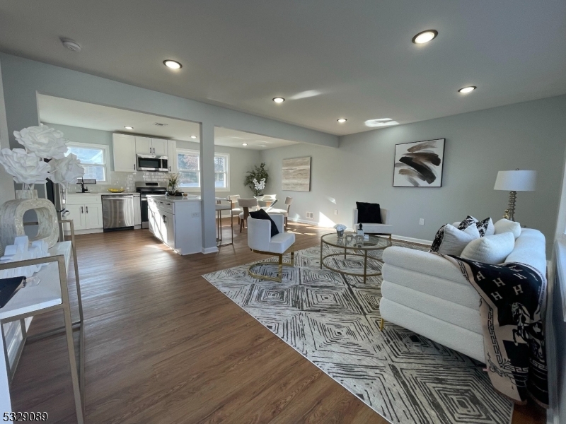 a living room with fireplace furniture and a wooden floor